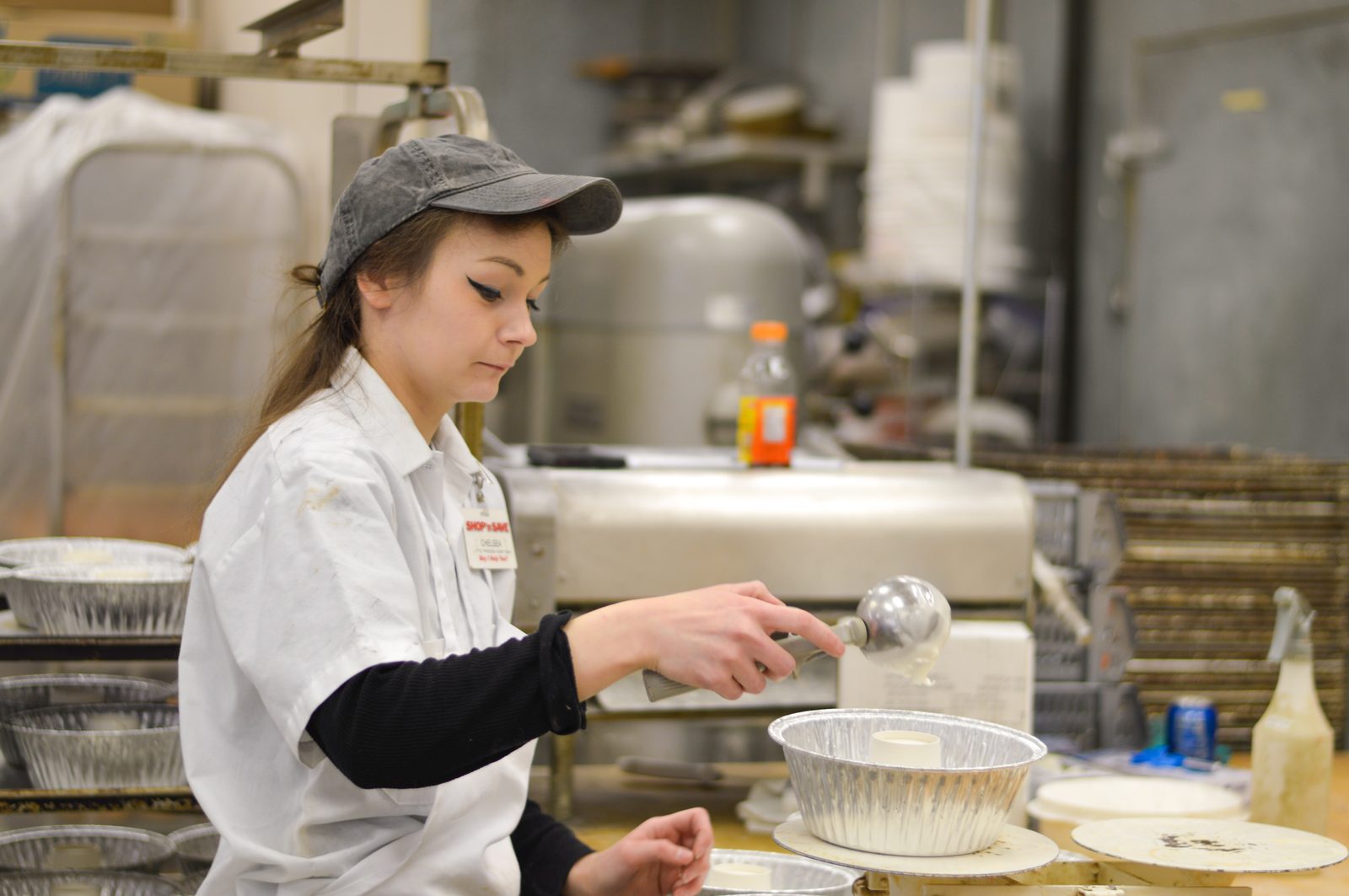 One of our bakers prepping pans in the bakery