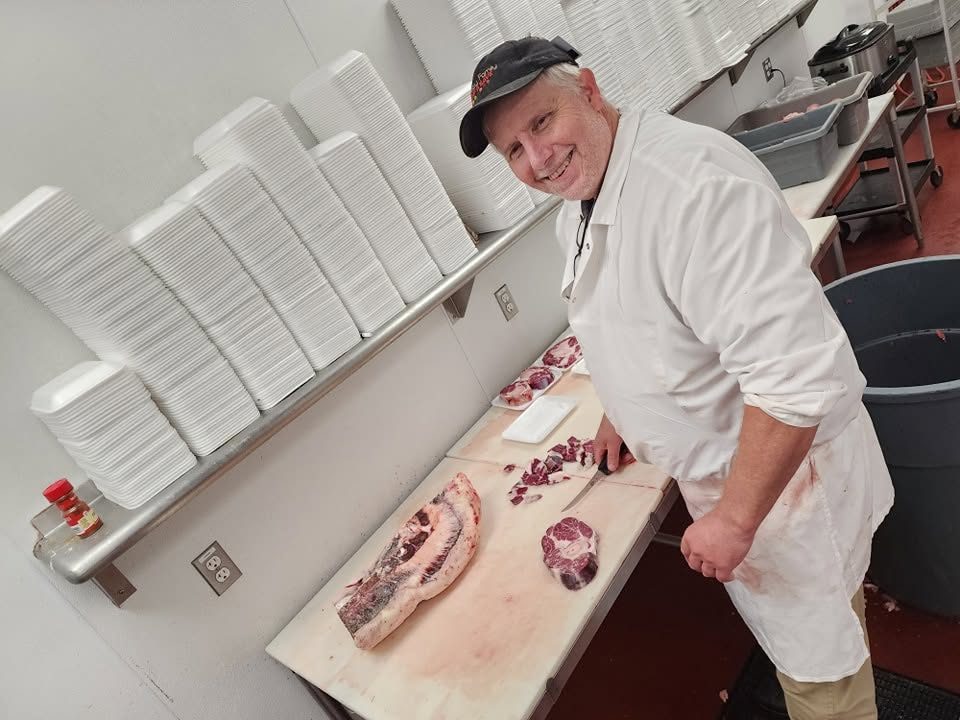 Eric, expert meat cutter, at work