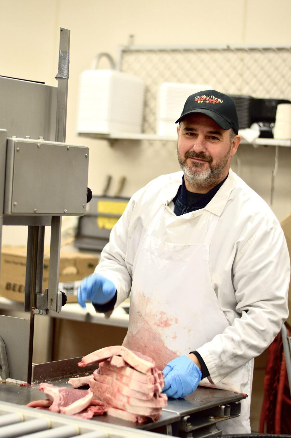 George, expert meat cutter, working the saw