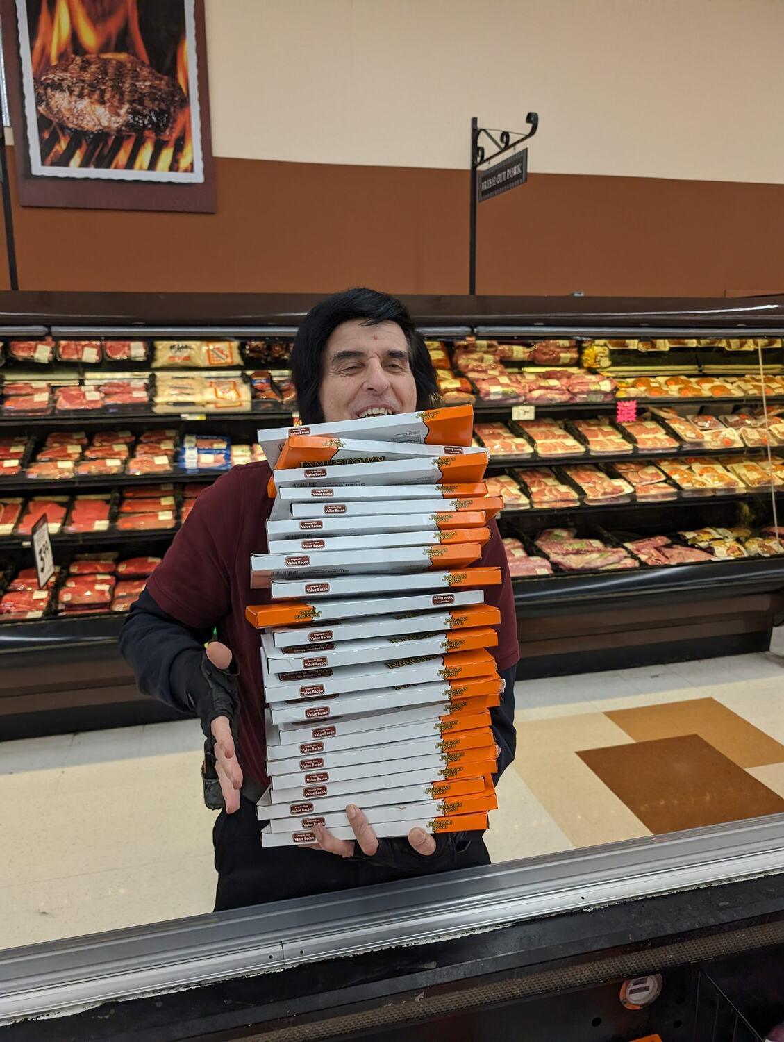 Tim with a leaning tower of bacon - about 20 packs!