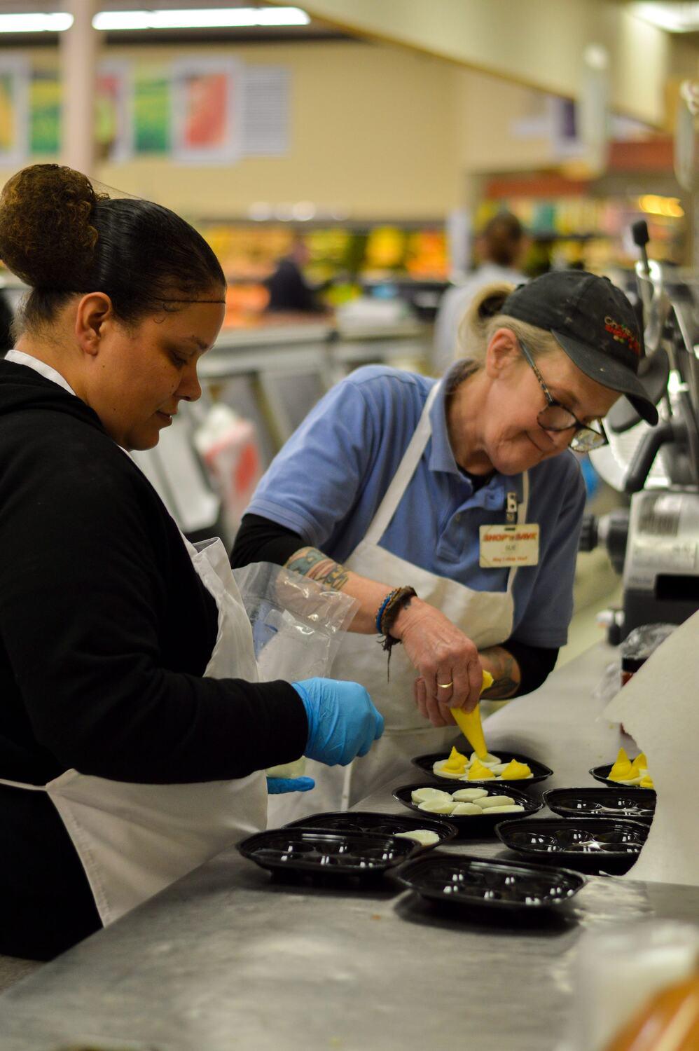 Sue and Alisha making fresh sides in our deli kitchen